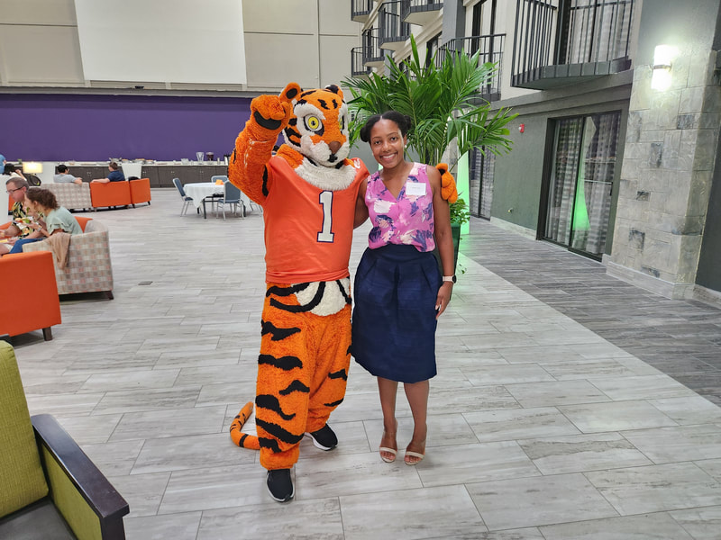 Keisha standing with Clemson's Tiger mascot